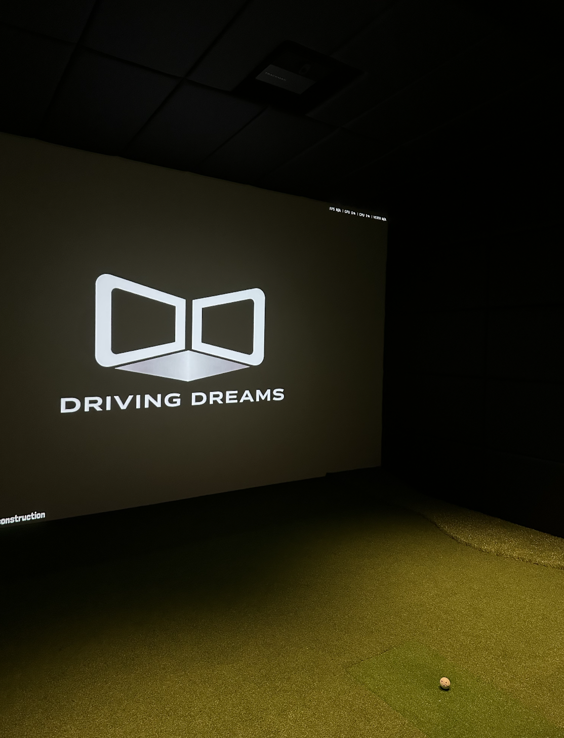 Groot projectiescherm in een donkere premium golfstudio